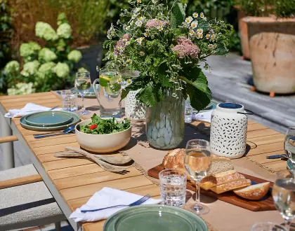 Outdoor tableware set out on a timber table