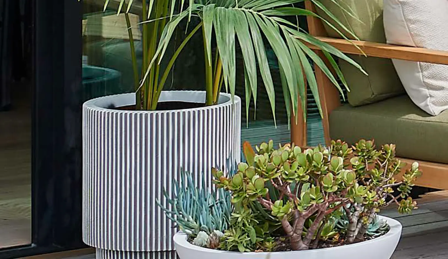 Planted bowl of herbs and succulents beside a large pot