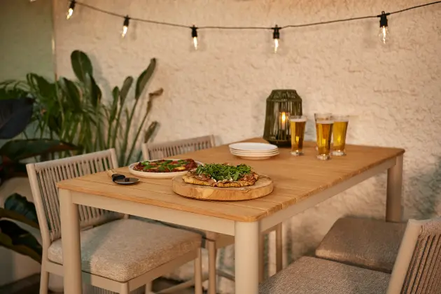 Outdoor dining table set with plates and glassware