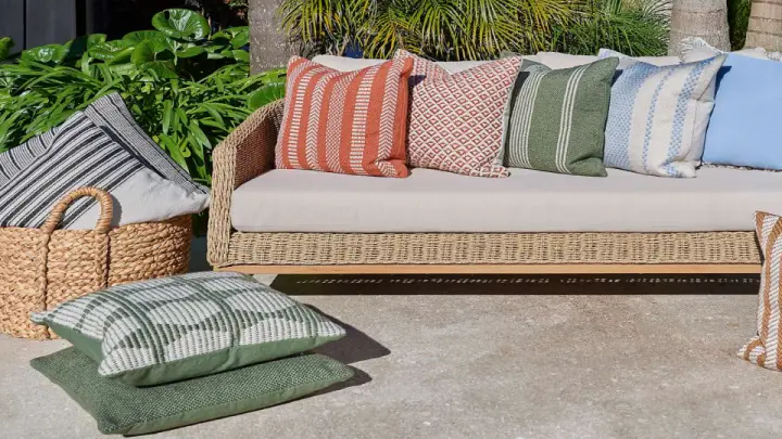Outdoor cushions and a throw on a lounge setting
