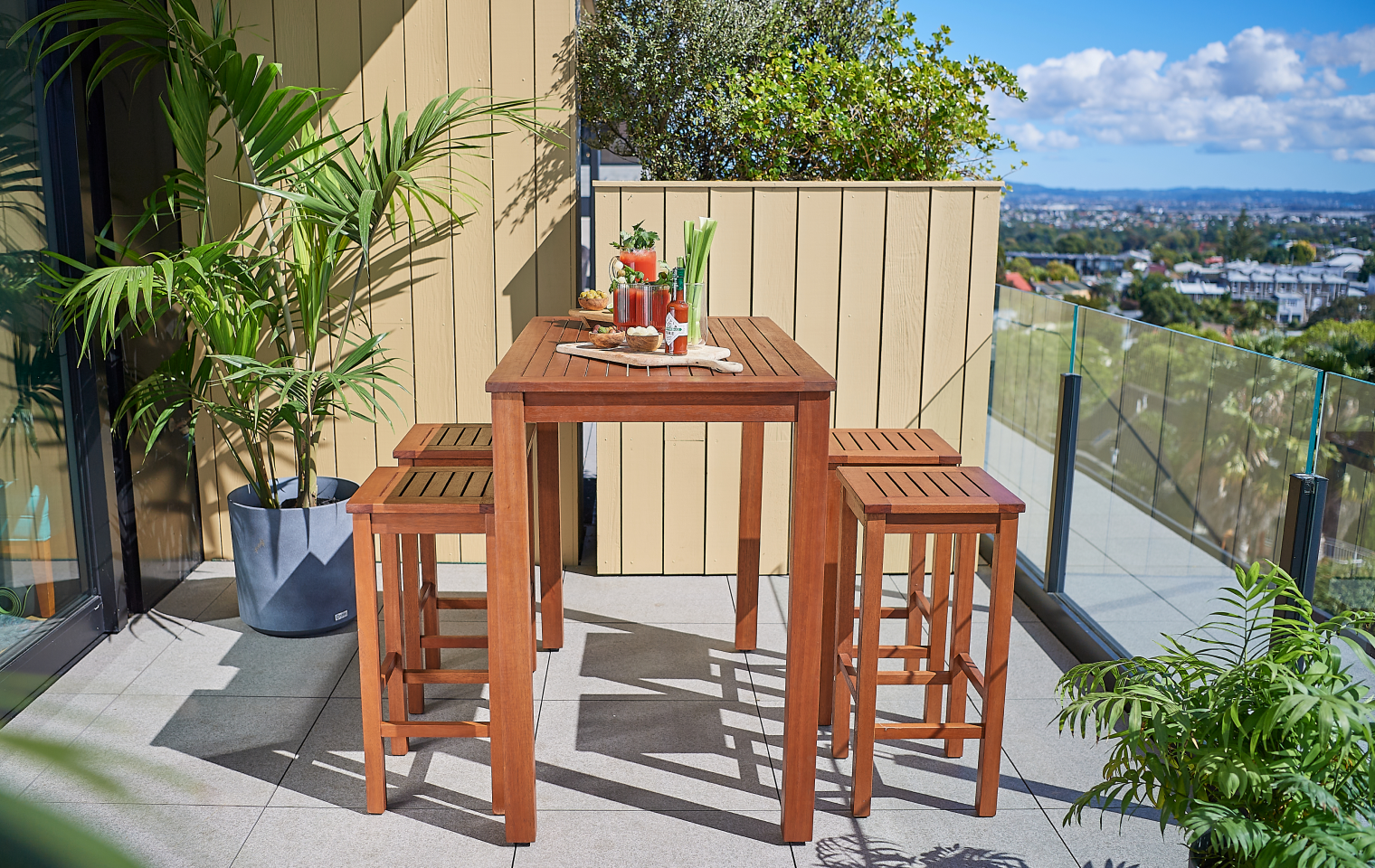 Balcony styled with a compact lounge setting, planters and a clear walkway