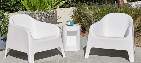 Wicker lounge chairs with cushions on a balcony