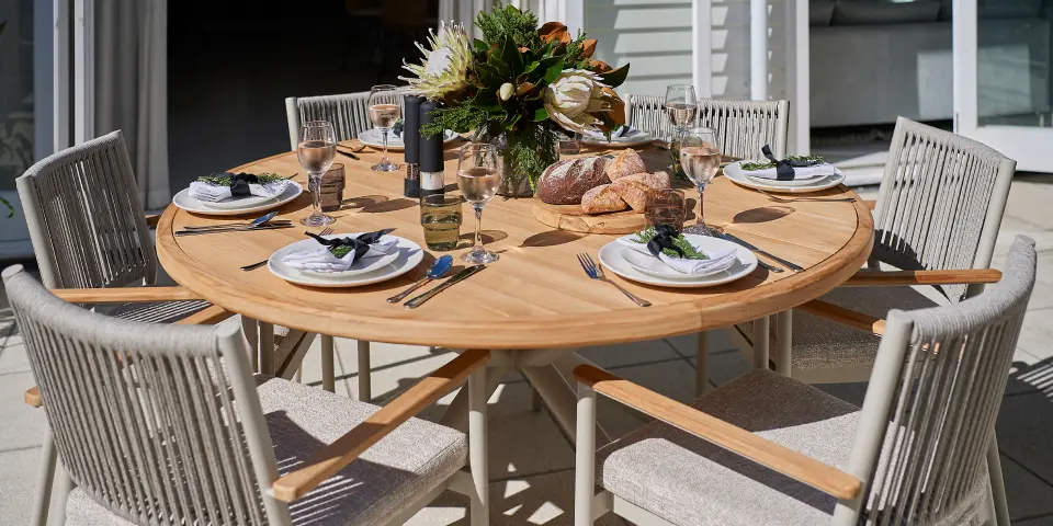Courtyard side table with greenery and privacy screening