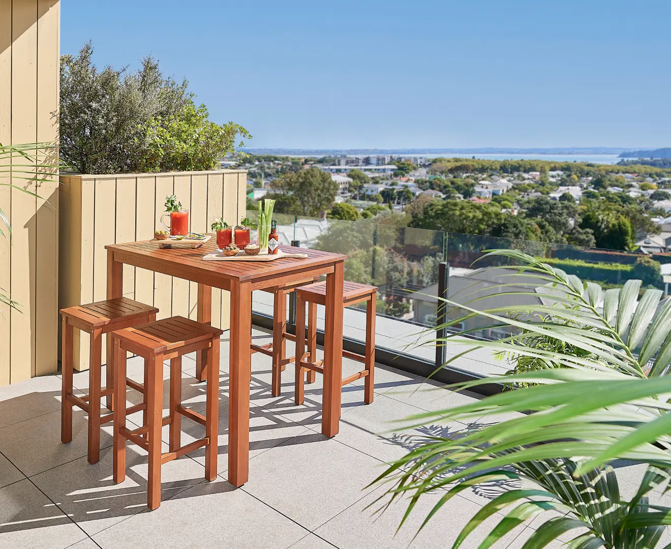 Compact bar setting on a balcony overlooking the city
