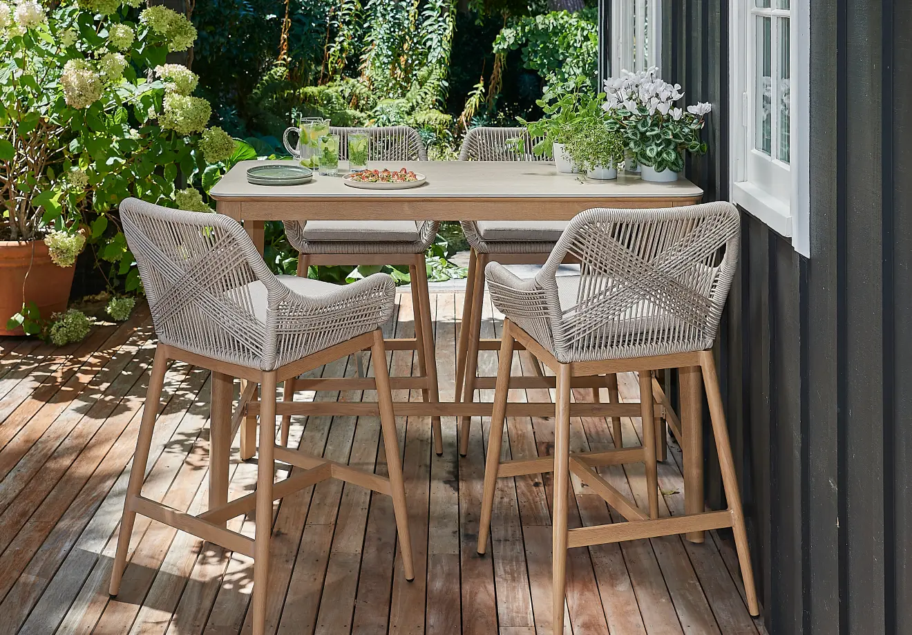 Small deck styled with a compact dining setting and a clear walkway