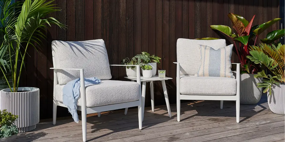 Small deck with a dining setting and potted plants