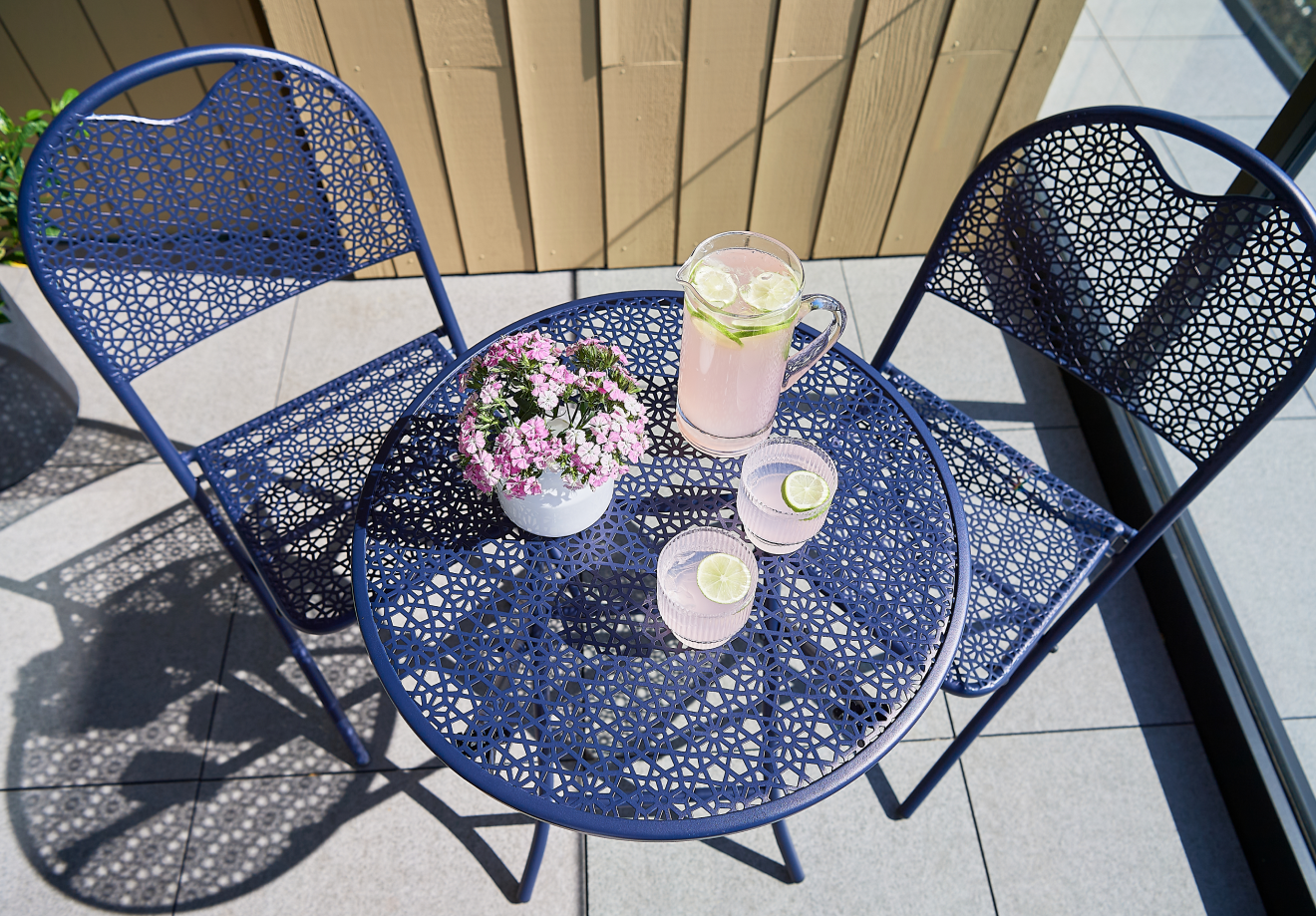 Balcony seating with cushions and a side table