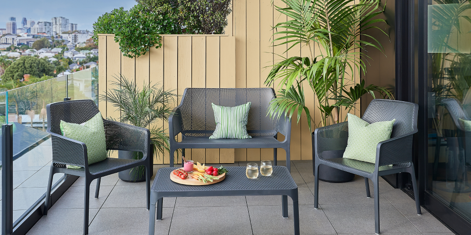Charcoal outdoor lounge setting on a small balcony